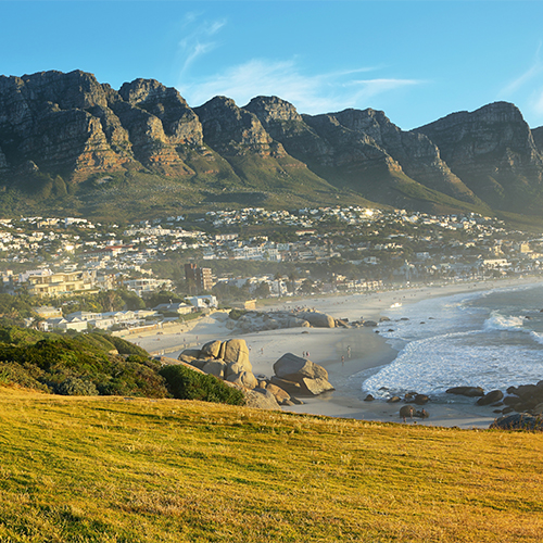 Camps Bay Beach in Cape Town, South Africa, with the Twelve Apostles in the background.