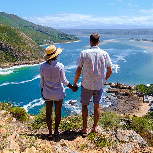lagoon of Knysna, South Africa. beach in Knysna, Western Cape, South Africa. A couple of men and a woman on a road trip at the garden route in South Africa